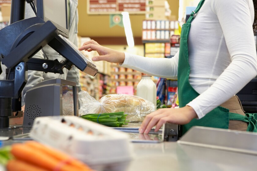 Cashier ringing up groceries