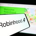 Stuttgart, Germany - 01-15-2025: Smartphone with logo of American financial company Robinhood Markets Inc. on screen in front of website.
