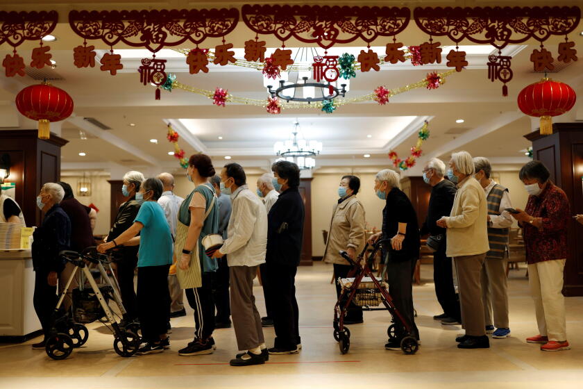 Residents queue for their buffet lunch at Heyuejia, a care home for the elderly, in Beijing, China May 26, 2021. Picture taken May 26, 2021. REUTERS/Carlos Garcia Rawlins