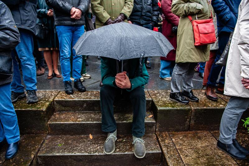 Nijmegen, Netherlands. 22nd Feb, 2024. A man shelters underneath an umbrella during the event. The 80th commemoration of the Bombing of Nijmegen which was unplanned attack by American aircraft on the city of Nijmegen, on 22 February 1944. Every February 2