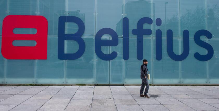 A man walks by the new logo and name for Belfius bank (formerly Dexia) in Brussels on Thursday, March 1, 2012. The bank unveiled its new name and logo on Thursday. (AP Photo/Geert Vanden Wijngaert)
