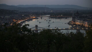 The Chain Bridge and the House of Parliament, right, are seen after turning off their illumination lights as part of nationwide energy-saving measures, in Budapest, Hungary, Tuesday, Aug. 4, 2026. (Zsolt Szigetvary/MTI via AP)