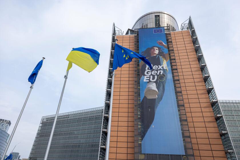 BRUSSELS, Belgium -May 7, 2022: Ukrainian and European flags blowing in front of the seat of the European Commission
