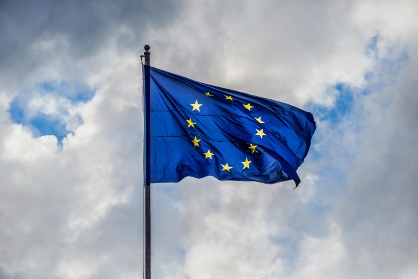 Problem in Europe. Dark and stormy clouds gather over European Union Flag