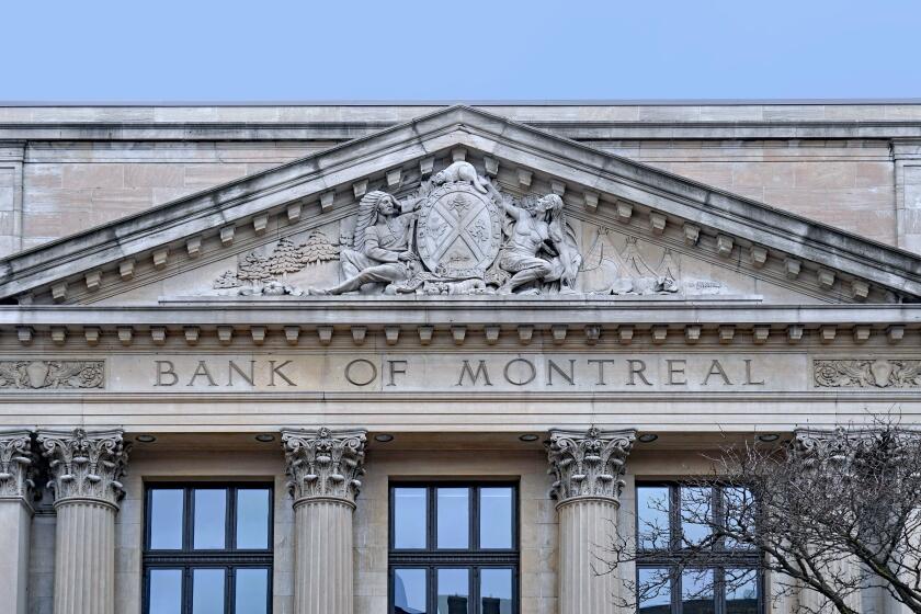 Stone coat of arms of Bank of Montreal on traditional classical style building