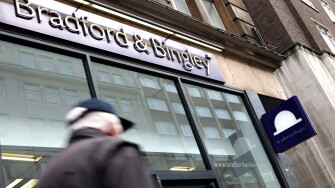 Commuters pass by a branch of Bradford & Bingley in central London, United Kingdom in 2009.