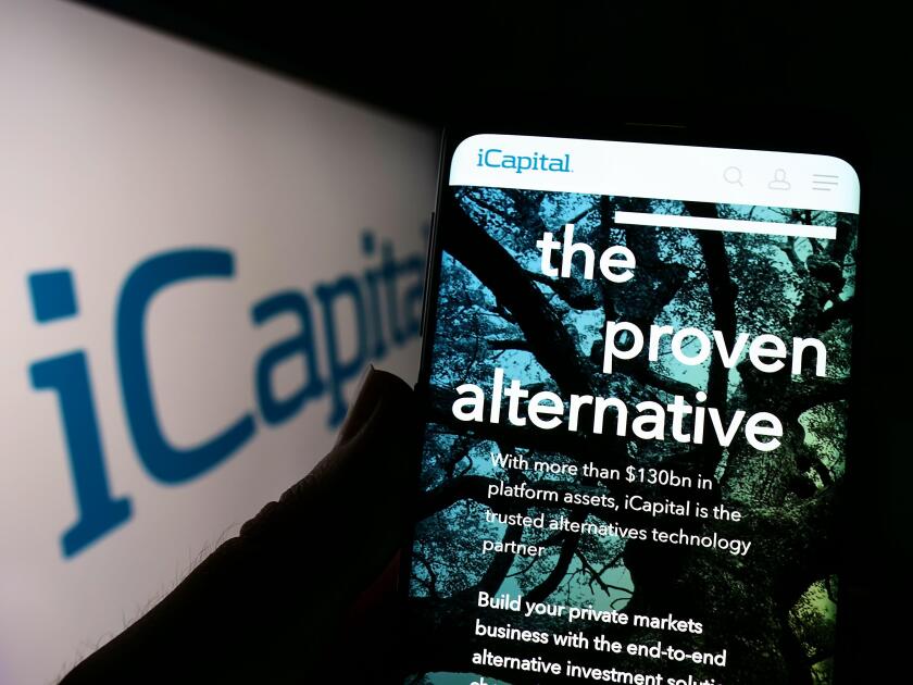 Person holding cellphone with website of Institutional Capital Network Inc. (iCapital) on screen with logo. Focus on center of phone display.