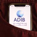 KONSKIE, POLAND - August 04, 2021: Abu Dhabi Islamic Bank logo displayed on mobile phone