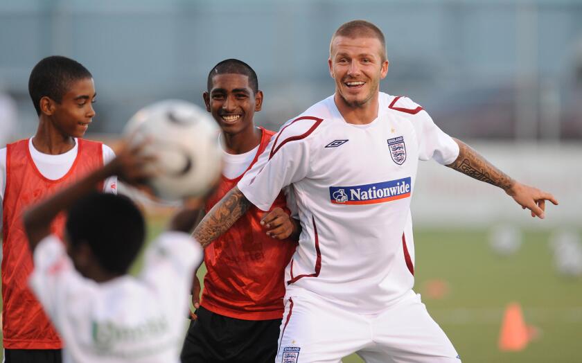 England's David Beckham during a soccer clinic for local school children at the Marvin Lee Stadium, Port of Spain, Trinidad.