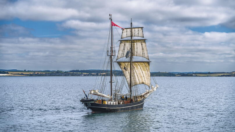Classic maritime vessel in serene seascape.