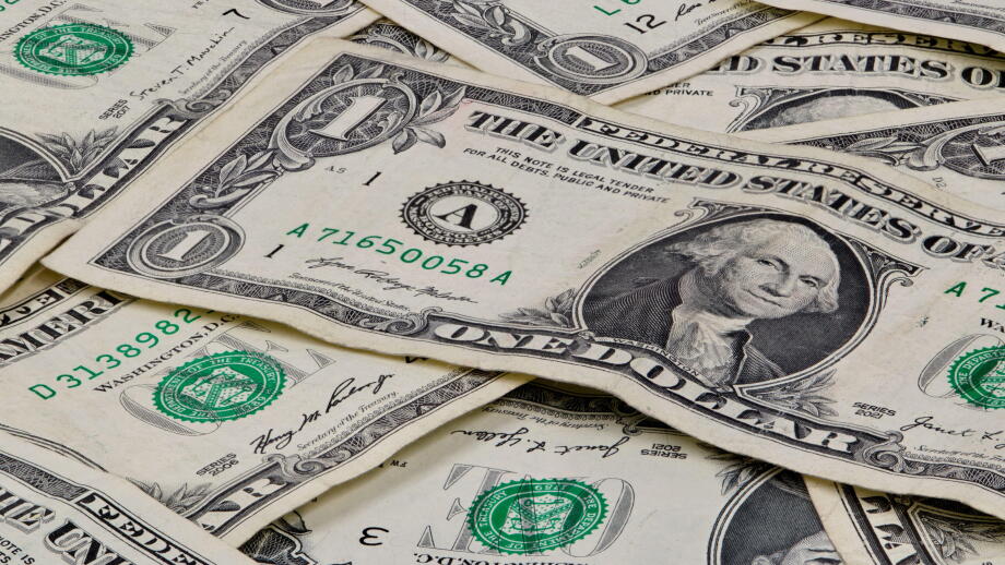 Pile of used US dollars partial cash bills money closeup finance economy concept.
