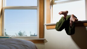 Boy climbing out of window