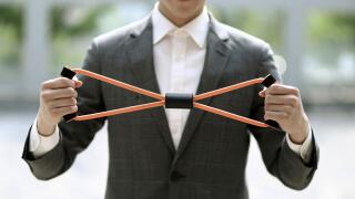 Businessman exercising with resistance band