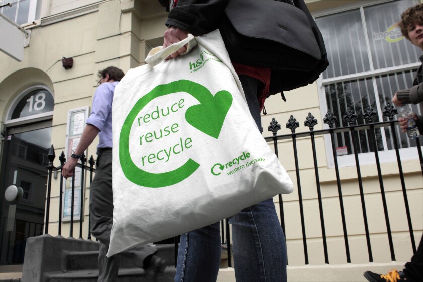 Not a plastic bag: "reduce reuse recycle" slogan on a cotton shopping bag.