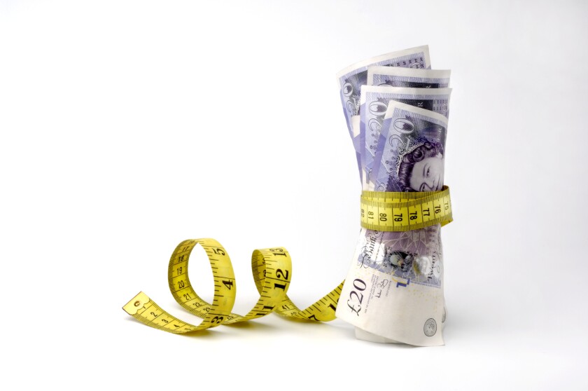 £20 notes being squeezed by a tape measure