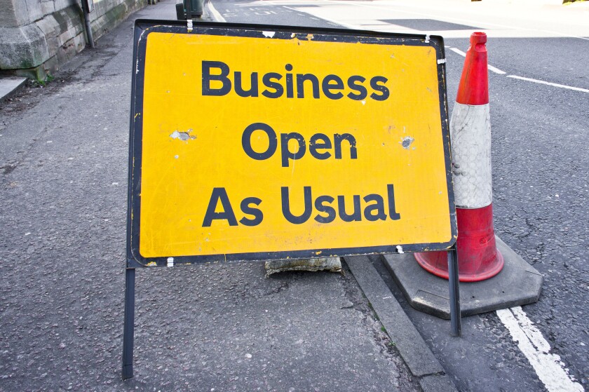 Road sign stating business open as usual during period of road works