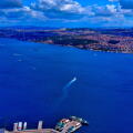 Aerial drone view of Bosphorus Strait with Dolmabahce Palace waterfront, ferries crossing between Europe and Asia, Istanbul, Turkey
