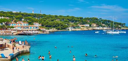 Scenic Seaside Beach Resort with Tourists Enjoying Swimming and Relaxing Under Umbrellas at La Garoupe beach, Cap d'Antibes, Cote d'Azur, France