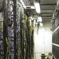 Fiber optic equipment in a data center, IT and modern technologies concept. Server room routers and fiber optical cables