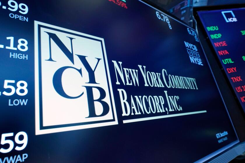 The logo for New York Community Bancorp is displayed above a trading post on the floor of the New York Stock Exchange, Wednesday, Jan. 31, 2024. New York Community Bancorp Inc. on Wednesday reported a loss of $252 million in its fourth quarter. (AP Photo/