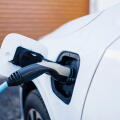 Power cord charging electric car at station