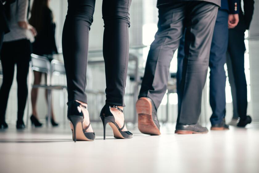 close up. a variety of business people passing through the office business center.
