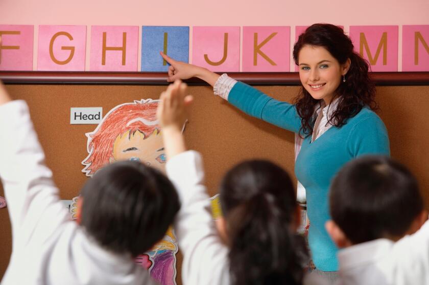 Teacher teaching alphabet in class