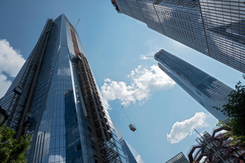 Residential and commercial skyscrapers under construction near the Hudson Yards subway on the west side of Manhattan, New York City.