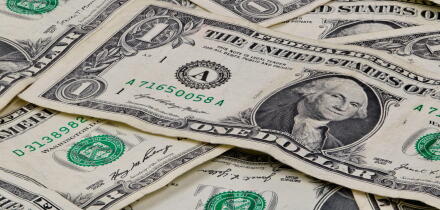 Pile of used US dollars partial cash bills money closeup finance economy concept.