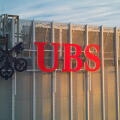 UBS logotype on the top of the UBS office during sunrise. UBS AG is a Swiss global financial services company with its headquarters in Zurich and Base