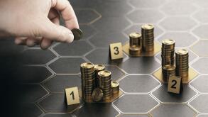 Human hand stacking generic coins over black background with hexagonal golden shapes. Concept of angel investor and investing in startup companies. Co