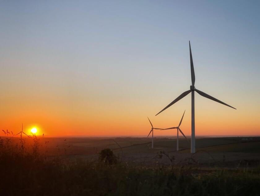 Renewable Energy - Cornwall Wind Turbines flowing in the sunset.