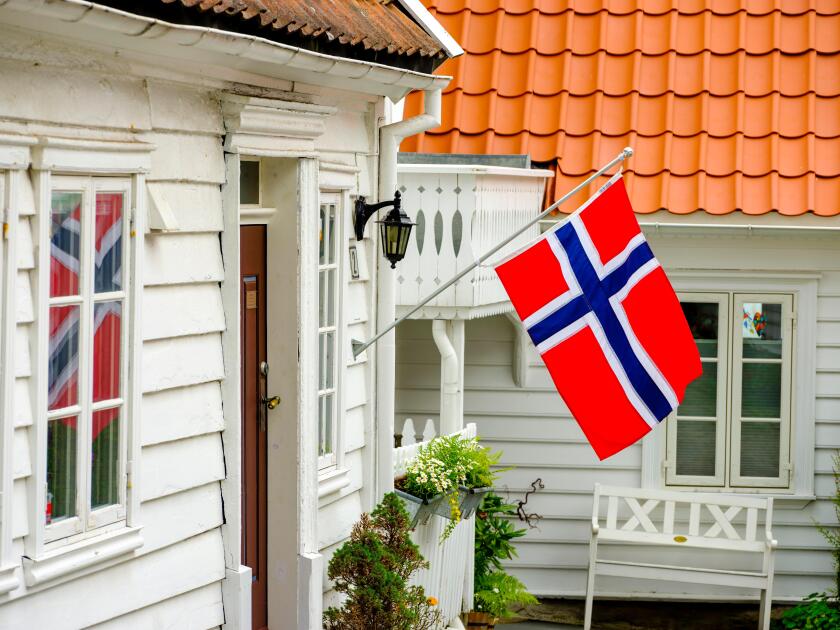 Norwegian flag on white wooden house, Stavanger, Rogaland, Norway