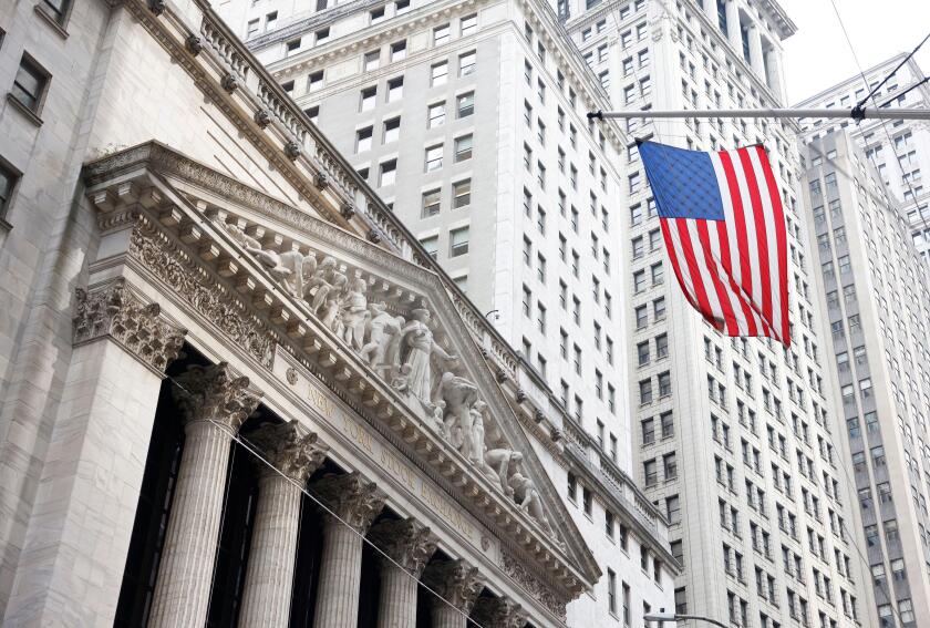 New York, United States. 22nd July, 2024. An American flag hangs near the entrance to the New York Stock Exchange (NYSE) on Wall Street in New York City on Monday, July 22, 2024. Markets were up slightly at the open after President Joe Biden's surprise an