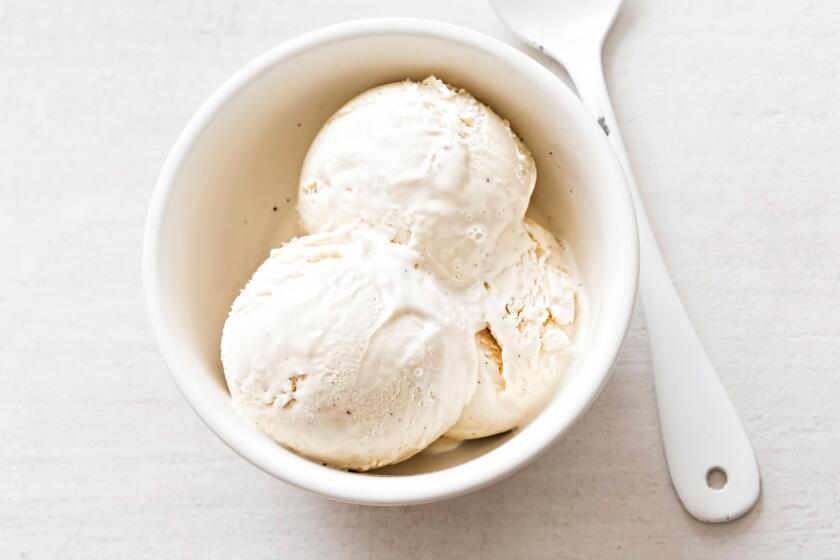 Vanilla ice cream scoops in white bowl